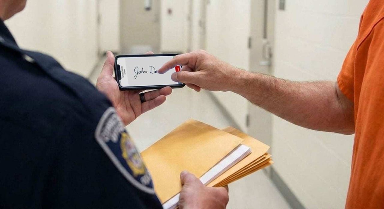 Correctional officer marking an item delivery to an inmate